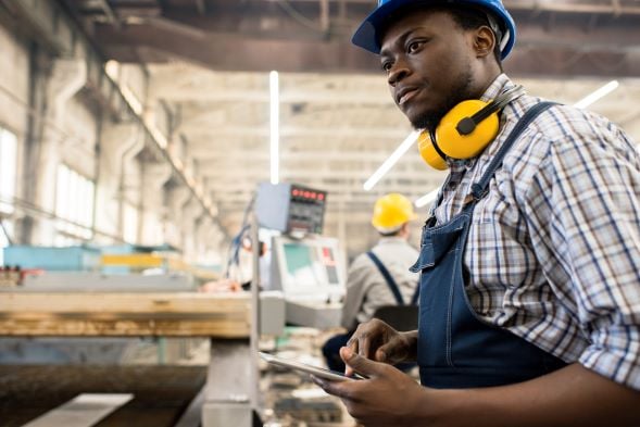 Onboarding worker getting familiar with production processes on employee app